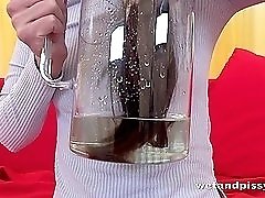 Tattooed chick pisses in a pitcher and pours it on herself